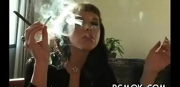  Older doxy holding a cigarette and playing with herself